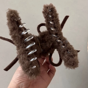 Detail of soft brown faux fur bow hair claw clip showing plush texture and acrylic teeth