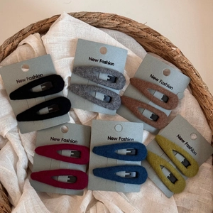 Detailed view of plush BB hair clips in six autumn colors on display cards