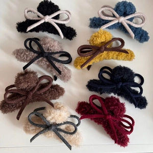Detailed set of plush hair claw clips in eight colors with ribbon bow accents for autumn