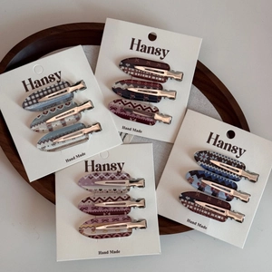 Set of 12 plaid and heart pattern hair clips on a wooden tray with cards