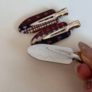 Close-up of three pieces set hair clips showing plaid patterns and silver metal base