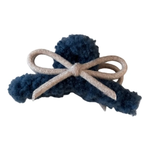 Deep blue plush bow hair claw clip with cream accents for elegant winter hairstyles