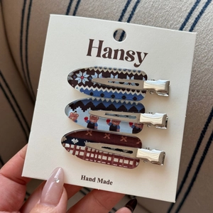 Three-piece set of decorative metal hair clips with blue snowflake and bear patterns