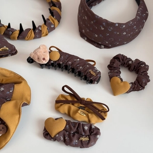 Detail view of vintage floral fabric hair claw clip and bow hairpin with handmade tag