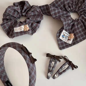 Detailed set of grey-blue plaid hair accessories including scrunchies and bear clips