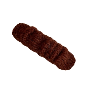 Minimalist dark brown knitted hair clip with warm wool texture on a white background