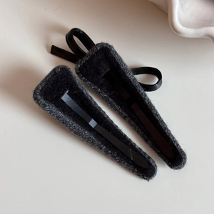 Detail of tweed fabric hair clips with rhinestone accents and leather ring decor