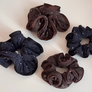 Close-up of retro knitted polka dot scrunchies with elegant ruffled edges for hair styling