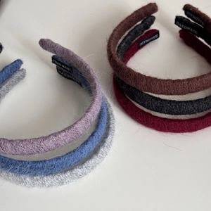 Detail of handmade knitted yarn headbands with professional HANDMADE fabric labels