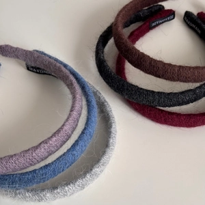 Detail of multi-color knitted fabric headbands showing the handmade woven label