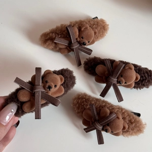 Detailed macro view of plush teddy bear hair clips with lamb wool and flocking texture
