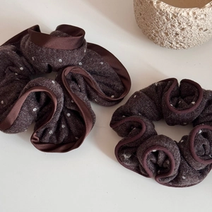 Close-up of brown polka dot knit hair scrunchies with elegant ruffled edges