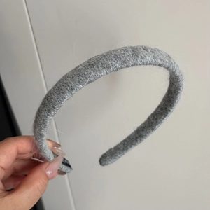 Detailed view of the fuzzy grey knitted texture on this warm autumn winter headband
