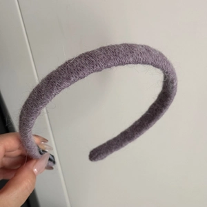 Detail of taro purple knitted headband with soft fuzzy mohair texture and black tip cover