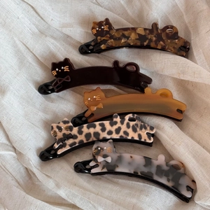 Cat-shaped acetate hair clips in leopard, tortoiseshell, and black finishes for women