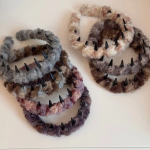 Detailed top view of assorted plush wave hairbands with anti-slip teeth in soft colors