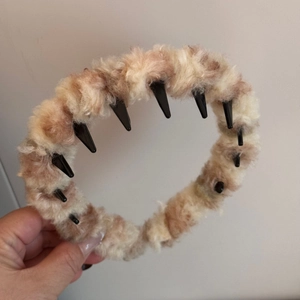 Detail showing plush leopard print headband with anti-slip inner teeth for hair fixing