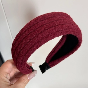 Dettaglio della fascia in maglia rosso vino che mostra la trama spessa e la fodera