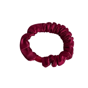 Elastic deep red satin scrunchie with glossy pleated silk texture for women's hairstyles