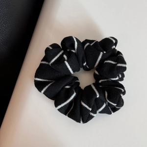 Détail rapproché du chouchou tricoté à rayures noires et blanches à haute élasticité