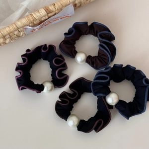 Detail of four-piece pleated hair ties with pearls and contrasting edge piping