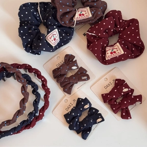 Detailed set of vintage polka dot hair accessories including scrunchies and bow clips