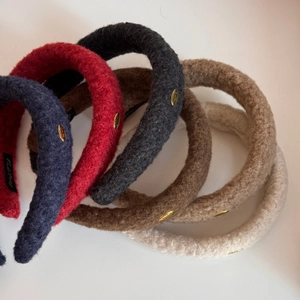 Plush winter headband with LOVE gold label and thick fleece fabric in neutral colors