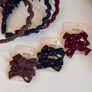 Detail of vintage polka dot scrunchie and bow clips in burgundy, navy, and brown set