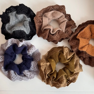 Five assorted knit and lace scrunchies in autumn tones including black brown and green colors