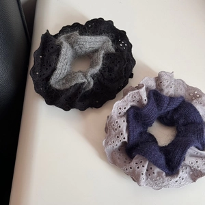 Detail of dual-layer hair scrunchies with intricate lace embroidery and soft knitted textures