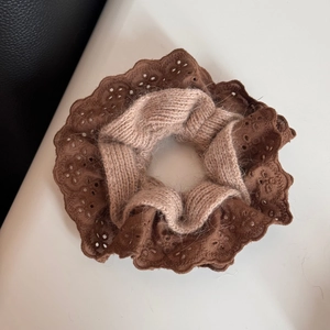 Detail of double-layer hair scrunchie with knit fabric and brown lace edges