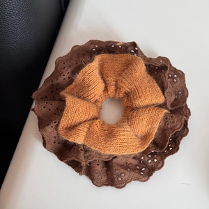 Detail of lace embroidery and knitted wool texture on autumn hair scrunchies