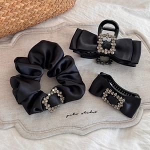 Detailed set of black satin bow hair accessories with sparkling rectangular rhinestone buckles