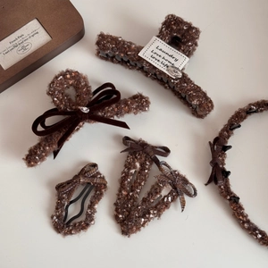 Vue détaillée du lot de pinces à cheveux en tweed marron et nœud en velours