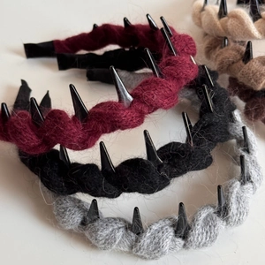 Detail view of knitted cable hairbands in multiple colors with non-slip tooth design