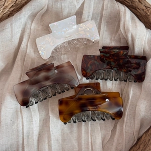 French style acetate hair claws in pearl, marble, and amber textures for women