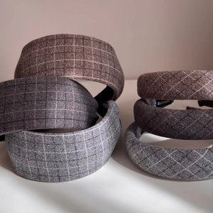 Close-up of wool texture hairbands with checkered patterns and handmade inner label
