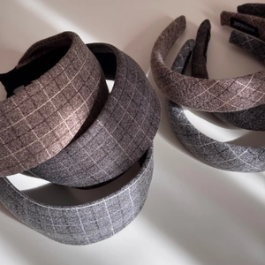 Close-up of wide plaid wool headband with handmade label and anti-slip lining