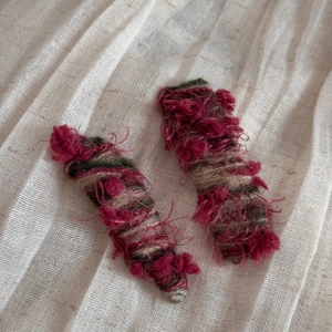 Detailed macro view of handmade wool-knitted hair clips with soft fuzzy texture