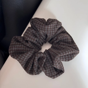 Detail shot of vintage plaid hair scrunchie with high-quality woven fabric texture