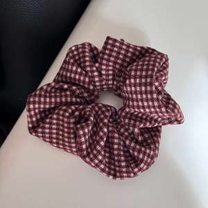 Close-up detail of red and white houndstooth fabric texture on an elastic headband