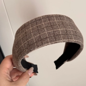 Detail view of brown plaid fabric headband with elegant wool texture and non-slip lining