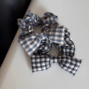 Close-up of blue and navy plaid cotton bow scrunchies with detailed fabric texture
