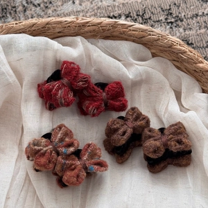 Knitted wool bow hair clips in deep red and brown tweed for autumn and winter