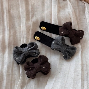 Detail view of handmade bow hair clips and ties with polka dot pattern and gold metal tag