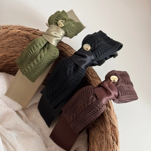Three premium knitted bow hair clips in olive, black, and maroon with gold accents
