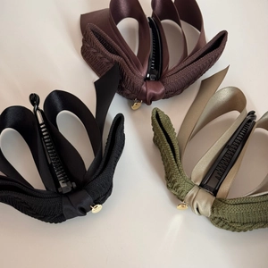 Double-layer bow banana clips in black, brown, and olive green with gold charms
