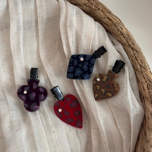 Flocked poker-themed hair clips with leopard print and rhinestones in four vintage styles