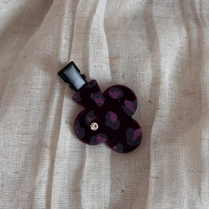 Close-up of velvet leopard print flower hair clip with rhinestone and metal duckbill clip