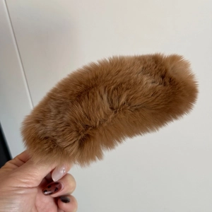 Gros plan sur la texture élégante en fourrure de vison d'une pince à cheveux marron
